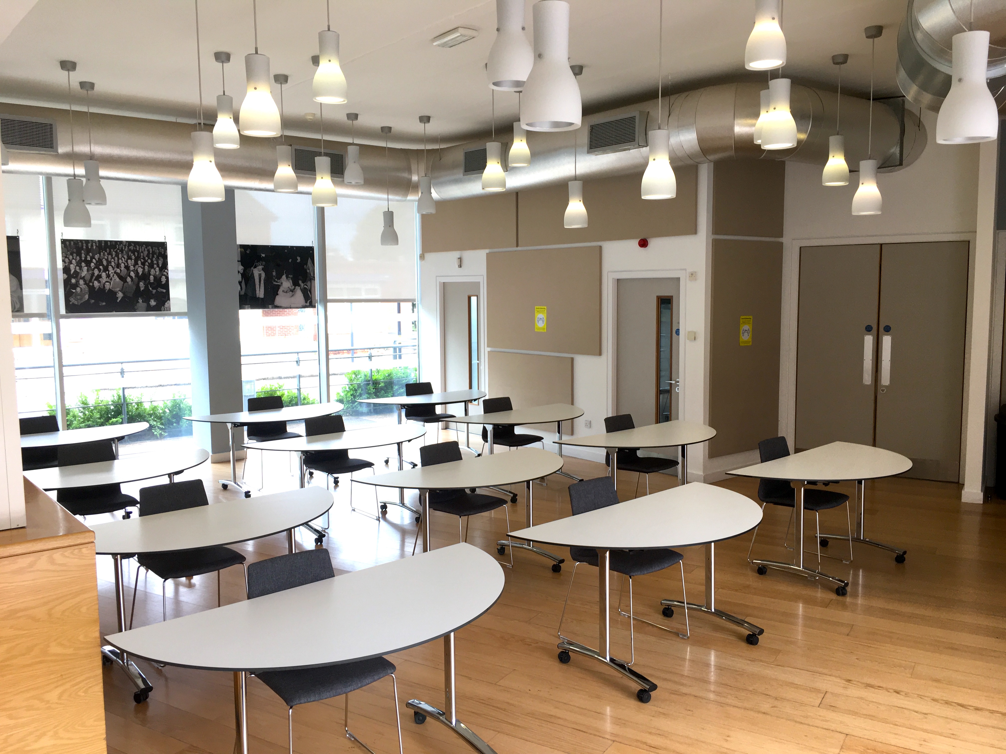 Photo of Duffield Room with tables and chairs laid out due to social distancing rules
